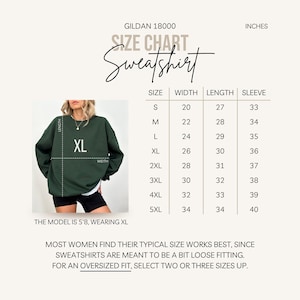 May include: Size chart for a Gildan 18000 sweatshirt, showing measurements in inches for width, length, and sleeve length for sizes S through 5XL. The chart includes a photo of a model wearing a green sweatshirt labelled XL.