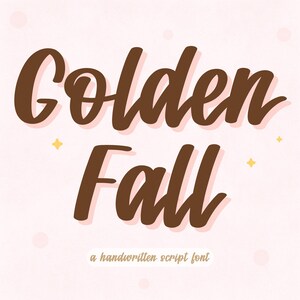 May include: A digital graphic with the words "Golden Fall" in a brown, handwritten script font. The text has a light pink shadow, with small yellow star and pink circle accents on a light pink background. The text "a handwritten script font" is below.