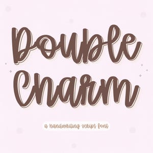 May include: A digital graphic featuring the words "Double Charm" in a brown, handwritten script font with a white outline. Below the text is the phrase "a handwriting script font" in a smaller, matching font.