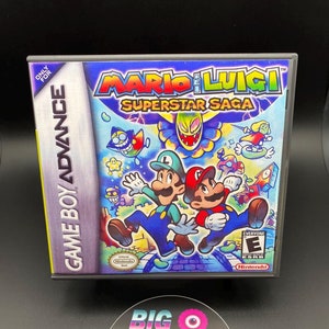 May include: A Game Boy Advance game cartridge for Mario & Luigi: Superstar Saga. The cartridge is black with a colorful image of Mario and Luigi on the front. The game is rated E for Everyone by the ESRB.