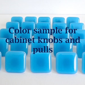 May include: Color sample for cabinet knobs and pulls in a bright turquoise blue.