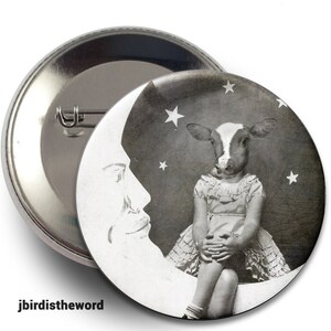 May include: A black and white photo of a cow with a human body sitting on a crescent moon. The cow is wearing a dress and has a sweet expression on its face. The moon is surrounded by stars.