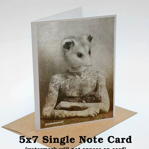 May include: A black and white photo of a possum with a human body, wearing a pearl necklace and tattoos. The possum is sitting with its arms crossed. The photo is on a 5x7 single note card.