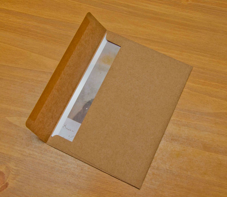 May include: A brown paper envelope with a white card inside. The card has handwritten text that says "Dear ...".
