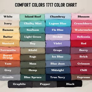 May include: Color chart displaying a variety of Comfort Colors 1717, including white, ivory, banana, butter, mustard, terracotta, burnt orange, yam, grey, granite, island reef, chalky mint, seafoam, light green, bay, khaki, sage, moss, hemp, blue spruce, graphite, pepper, black, chambray, lagoon blue, flo blue, orchid, violet, grape, ice blue, blue jean, midnight, true navy, blossom, crunchberry, watermelon, heliconia, red, berry, brick, crimson, chili, and espresso.