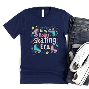 May include: Navy blue t-shirt with a graphic of roller skates and the text "In my roller skating era".