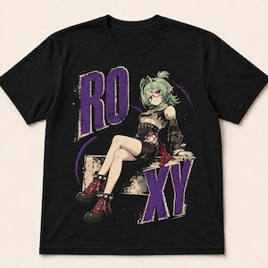 May include: A black short-sleeve t-shirt featuring a graphic print of an anime-style character with green hair and glasses. The character is sitting on a block with the purple text RO and XY printed in a distressed font on either side.