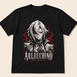 May include: A black short-sleeve t-shirt featuring a graphic print of an anime-style character with white hair and red eyes. The design includes red thorn-like accents and the text Arlecchino The Knave printed in a white serif font below.