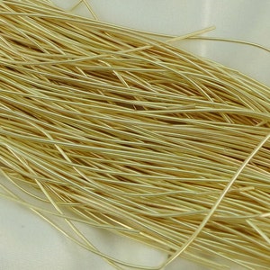 May include: A close-up of a bundle of gold-colored wire. The wire is thin and flexible, and it is perfect for crafting jewelry or other small projects.