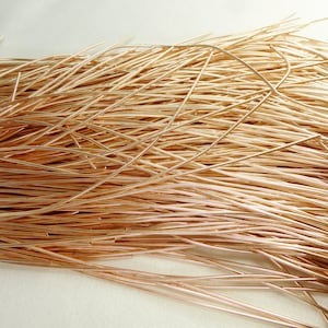 May include: A pile of thin, copper-colored wire. The wire is tangled and appears to be made of a soft, flexible material.