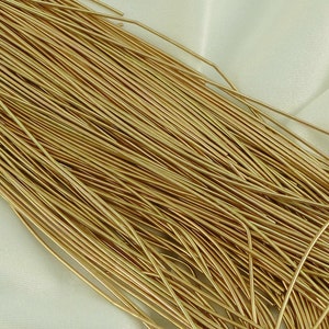 May include: A bundle of gold-coloured wire, ideal for crafting jewellery or other projects.