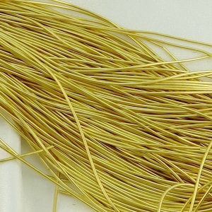 May include: A close-up of a bundle of gold-colored wire. The wire is thin and flexible, and it is perfect for crafting jewelry or other small projects.