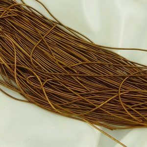 May include: A large bundle of gold-colored wire, likely used for jewelry making or crafting.