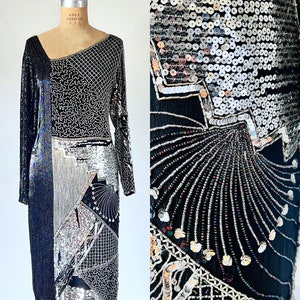 May include: A black and silver sequined dress with a geometric pattern. The dress has long sleeves and a fitted silhouette.