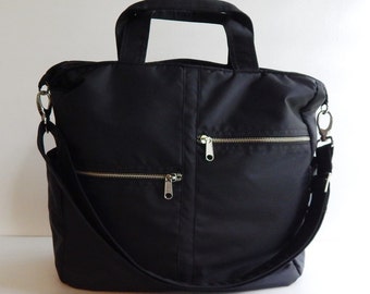 May include: Black nylon tote bag with a zippered pocket and a long adjustable shoulder strap.