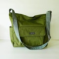 Dark Olive Water Resistant Nylon Crossbody Messenger Bag: Large light weight diaper or school bag with adjustable strap - KAILA product logo