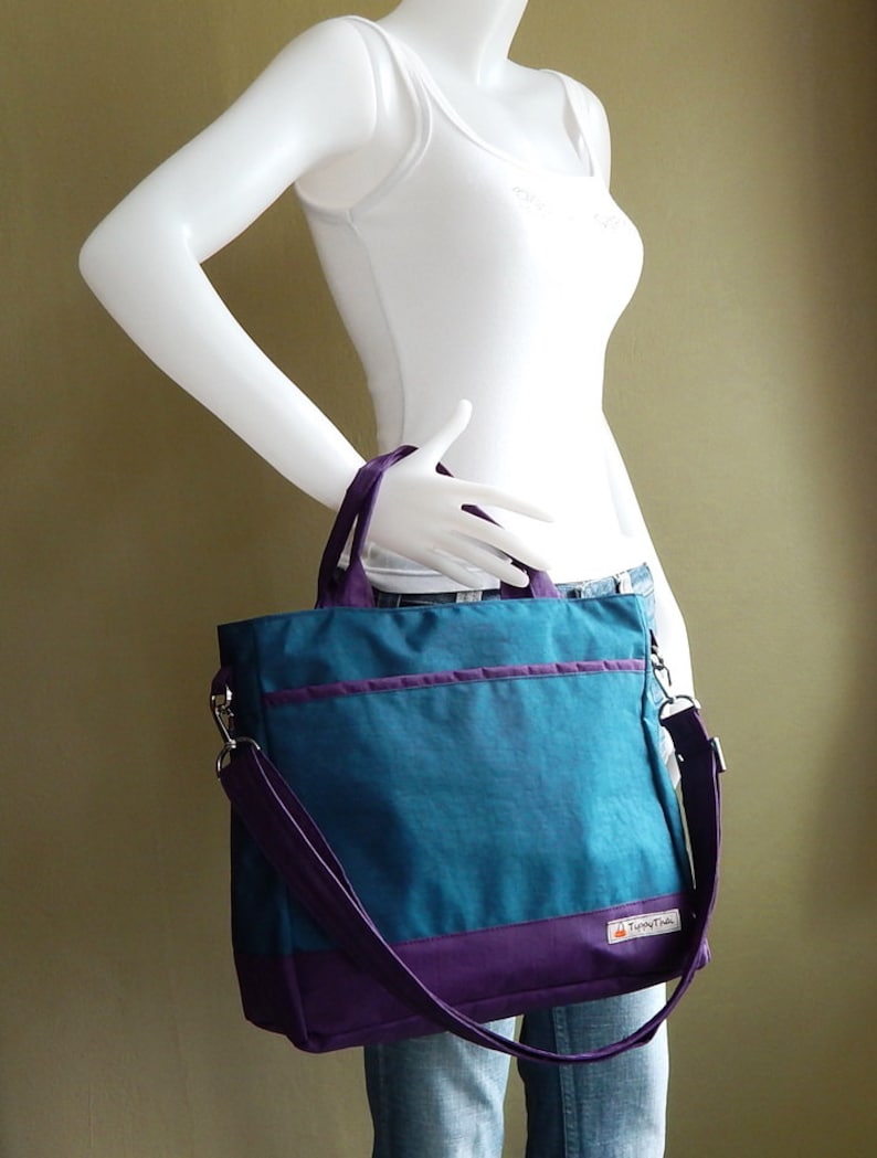 May include: A teal and purple tote bag with a purple shoulder strap and the text "Tingly Things" on the front.