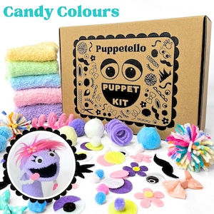 May include: A Puppetello puppet kit in a brown cardboard box with black illustrations of eyes, mustaches, and bows. The kit includes colorful fuzzy fabric squares, pom-poms, felt shapes, and a circular inset showing a finished purple puppet.