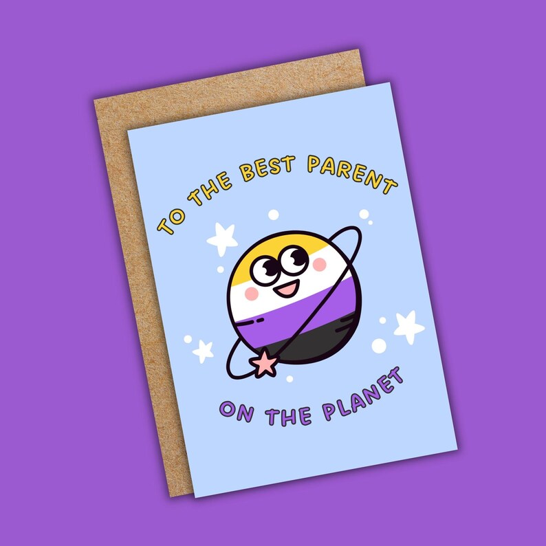 May include: A greeting card with a light blue background and a cartoon planet design. The planet is colored with yellow, white, purple, and black stripes. Text on the card reads "TO THE BEST PARENT ON THE PLANET."