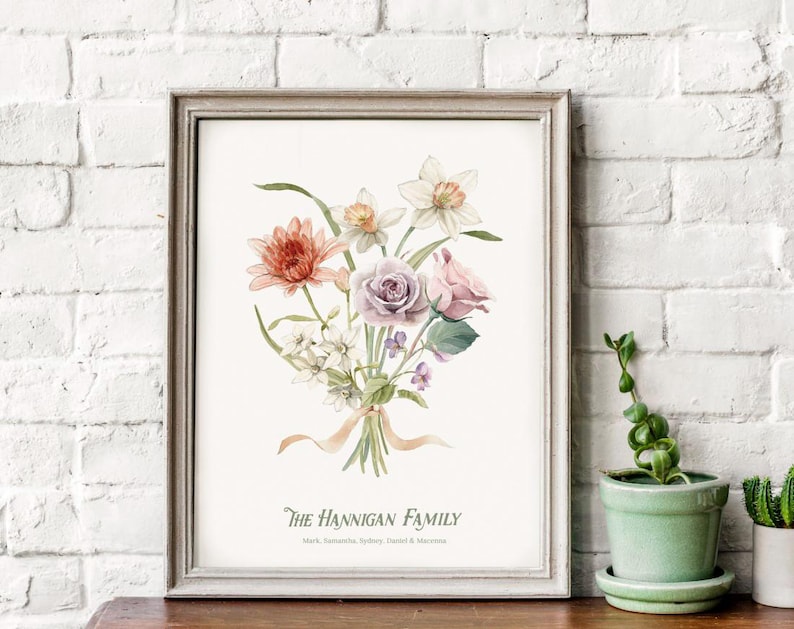 May include: A watercolor print of a bouquet of flowers in shades of pink, white, and orange. The flowers are arranged in a vase and the print includes the text "The Hannigan Family".