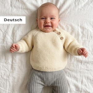 May include: A white ceramic mug with a black handle and the text "But First, Coffee" in a bold, black font. The mug is set against a blurred background, suggesting a cozy setting.