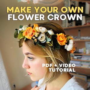 May include: A floral crown with orange and white flowers and green leaves. The text "MAKE YOUR OWN FLOWER CROWN" is displayed above the crown. The text "PDF + VIDEO TUTORIAL" is displayed below.