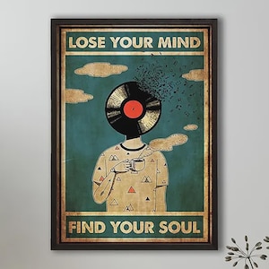 May include: A framed wall art print featuring a person with a vinyl record for a head, wearing a patterned t-shirt and holding a steaming mug. The text reads LOSE YOUR MIND at the top and FIND YOUR SOUL at the bottom against a teal background.