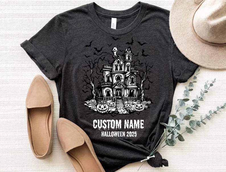 a t-shirt with a Halloween-themed graphic, a hat, and some shoes, all laid out on a white surface.