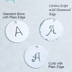 May include: Three silver metal discs with the letter "A" engraved in different styles. The top disc has a hammered edge and says "Corsiva Script with Hammered Edge". The middle disc has a plain edge and says "Standard Block with Plain Edge". The bottom disc has a plain edge and says "Curlz with Plain Edge".