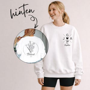 Puede incluir: Sudadera blanca con un diseño floral en la espalda y un diseño cruzado con iniciales y el nombre "Sophie" en la parte delantera. La parte trasera de la sudadera tiene la palabra "Braut".