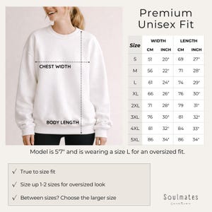 May include: A white unisex sweatshirt with chest width and body length measurements. The size chart shows measurements in inches and centimeters, ranging from size S to 5XL. The model is 5'7" and wearing a size L for an oversized fit. The text says "Premium Unisex Fit".