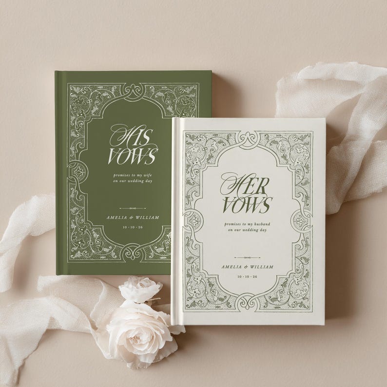 May include: Two wedding vow books, one olive green and one cream, with ornate floral borders. The green book reads "His Vows" and the cream book reads "Her Vows". Both books include the names Amelia & William and the wedding date.
