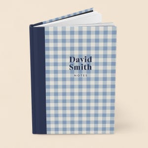 May include: A hardcover notebook with a blue and white gingham pattern. The spine is a solid navy blue. The cover features the name "David Smith" and the word "NOTES" in a dark blue font.