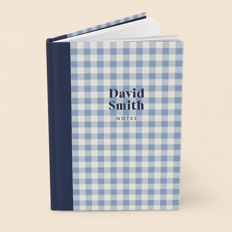 May include: A hardcover notebook with a blue and white gingham pattern. The spine is a solid navy blue. The cover features the name "David Smith" and the word "NOTES" in a dark blue font.