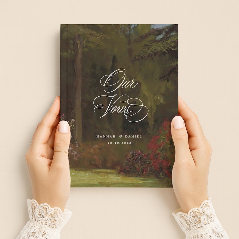 May include: A rectangular vow book featuring a dark, painterly forest landscape with deep green trees and red floral accents. The white text reads Our Vows, followed by the names Hannah & Daniel and the date 10.10.2026 in a clean, serif font.