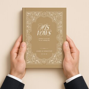 May include: A gold-colored book titled "His Vows" with ornate white detailing. The book includes the names Isabel & Sebastian and the wedding date 09-26-26. The book is held by two hands.
