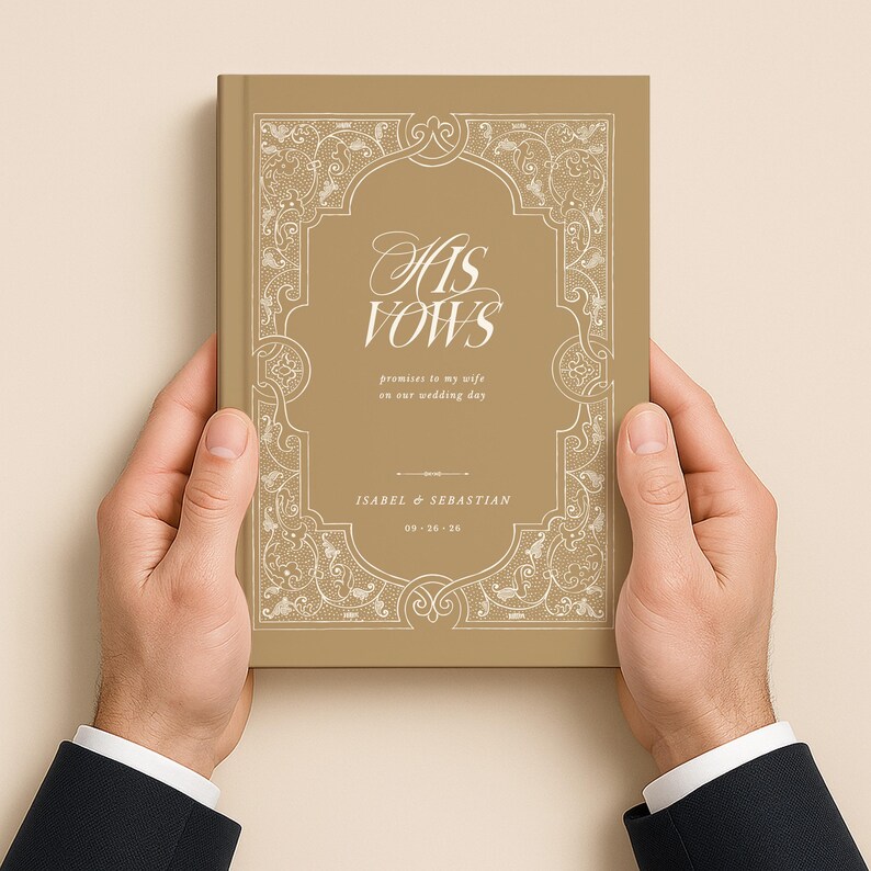 May include: A gold-colored book titled "His Vows" with ornate white detailing. The book includes the names Isabel & Sebastian and the wedding date 09-26-26. The book is held by two hands.