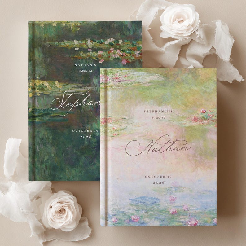 May include: Two hardcover vow books featuring impressionist water lily paintings. The left book is dark green with text reading Nathan's vows to Stephanie October 10 2026. The right book is light pink and blue with Stephanie's vows to Nathan October 10 2026.
