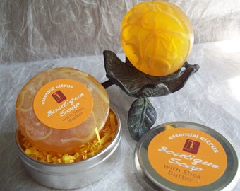 Essential Citrus Revitalizing Soap, 2 oz glycerin artisan soap with essential oils and soap shreds in a round tin