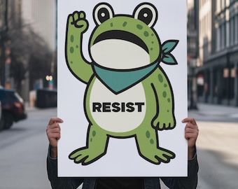 May include: A white sign featuring a cartoon frog with a teal bandana and the word "RESIST" in bold black letters. The frog is green with black eyes and is raising its fist. The sign is held in front of a person in a city setting.