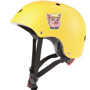 May include: A bright yellow helmet with black straps and a red buckle. The helmet features a cartoon pig with blonde hair and the text "QUIET PIGGY". This helmet is designed for safety and protection.
