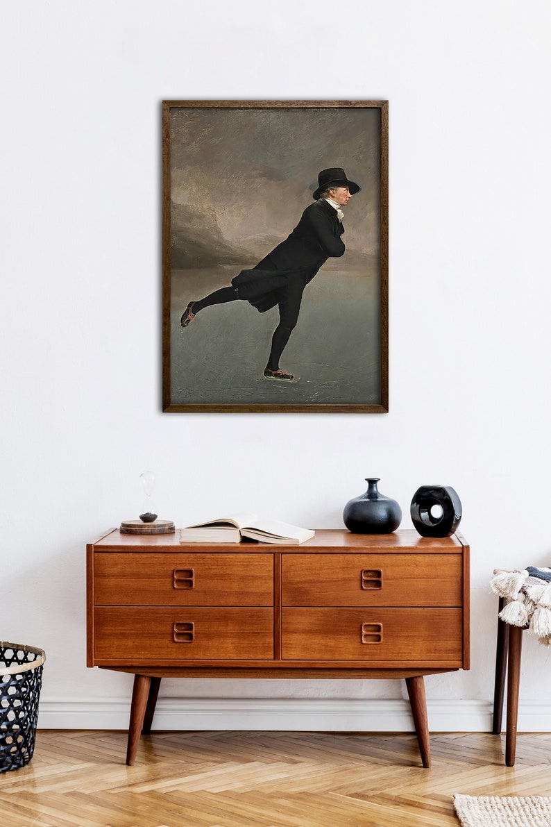 May include: A painting of a man in a black coat and top hat ice skating on a frozen lake. The background is a cloudy sky with mountains in the distance.