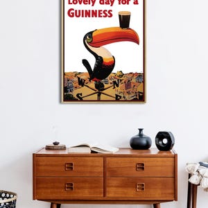 May include: A vintage Guinness advertisement featuring a toucan holding a glass of Guinness with the text "Lovely day for a GUINNESS".