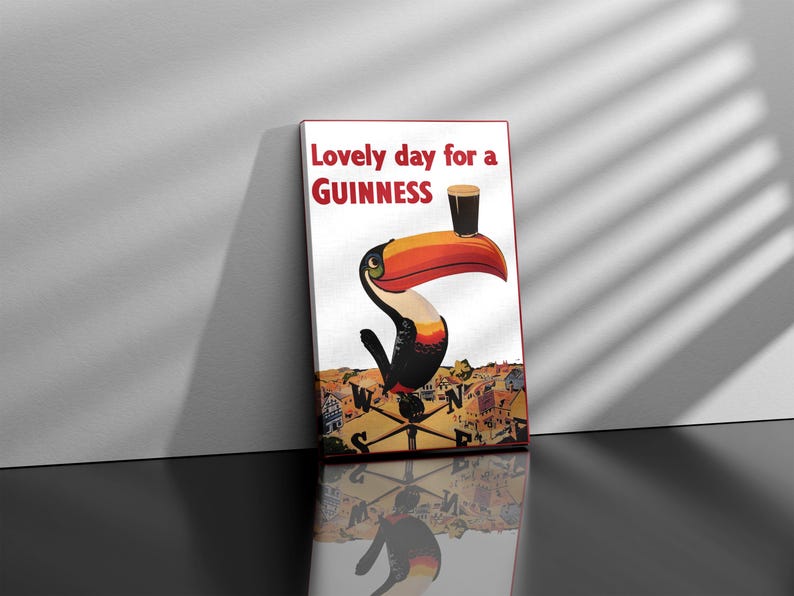 May include: A vintage Guinness advertisement featuring a toucan holding a glass of Guinness with the text "Lovely day for a GUINNESS".