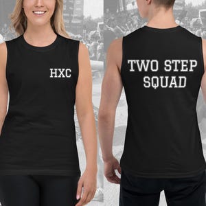 May include: Black sleeveless muscle tank top with white text on the front that says "HXC" and white text on the back that says "TWO STEP SQUAD".