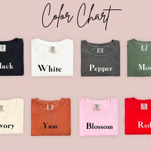 May include: Colour chart showing 10 different colours of t-shirts. The colours are: Black, White, Pepper, Moss, Ivory, Yam, Blossom, Red.