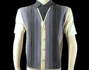 May include: A short-sleeved shirt with a vertical striped pattern in shades of gray and blue. The shirt has a button-up front and a contrasting cream-colored collar and sleeves. The shirt is displayed on a mannequin.
