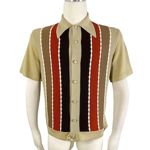 May include: A short-sleeved shirt in tan with a vertical striped design in brown, red, and white. The shirt has a collared neckline and button-up front. The bottom hem features a buckle closure.