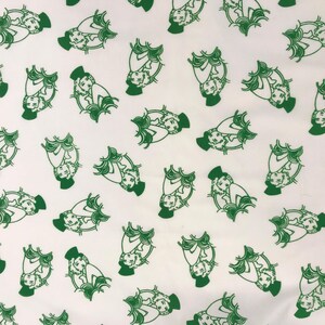 May include: White fabric featuring a repeating pattern of green illustrations. Each illustration shows a person seated, wearing a hat and surrounded by stylized foliage. The design is evenly spaced across the fabric.