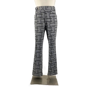 May include: Black and white patterned pants with a wide leg silhouette. The pants have a high waist and a belt loop detail.